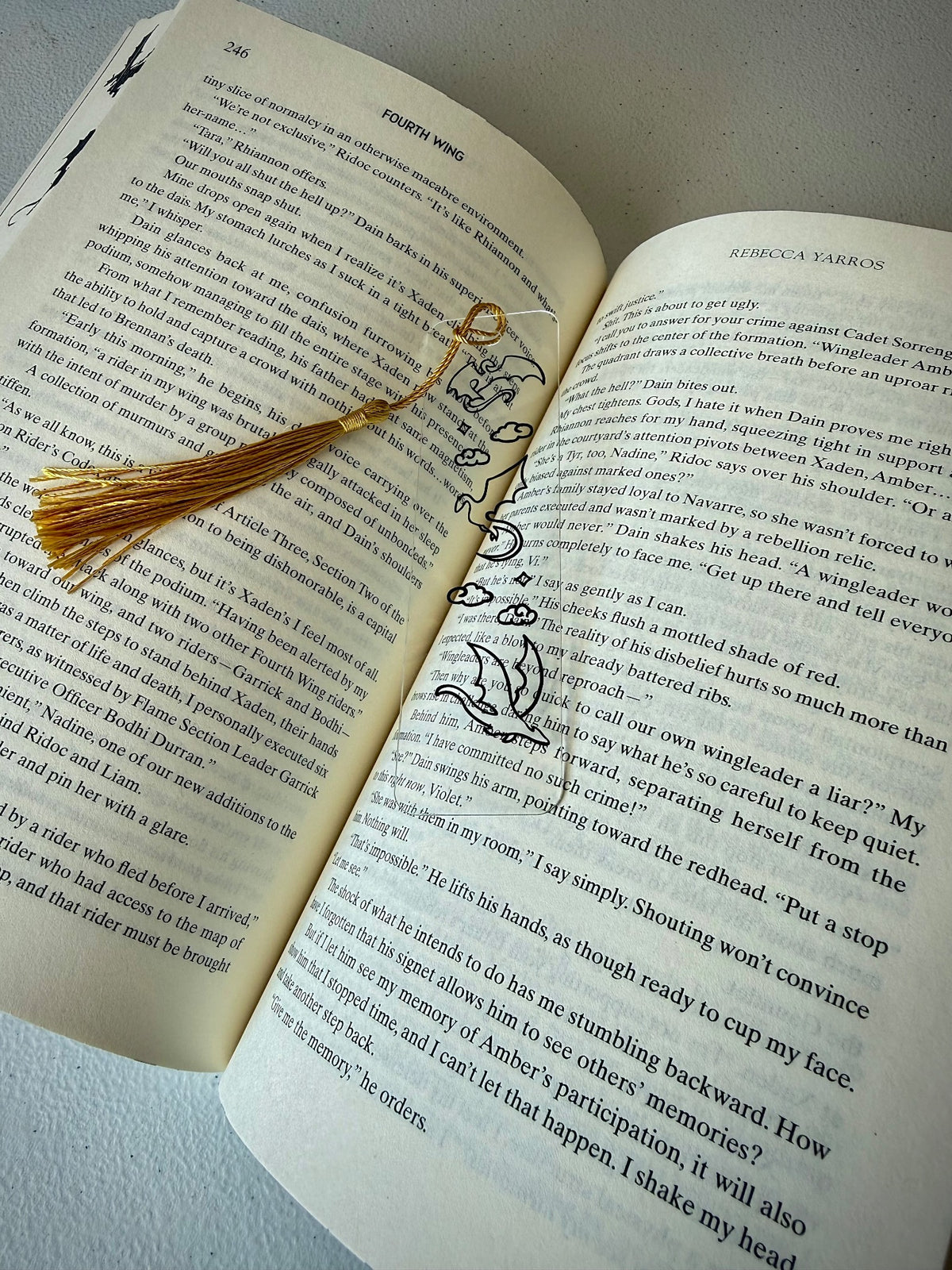 Clear dragon line-art bookmark with a gold tassel