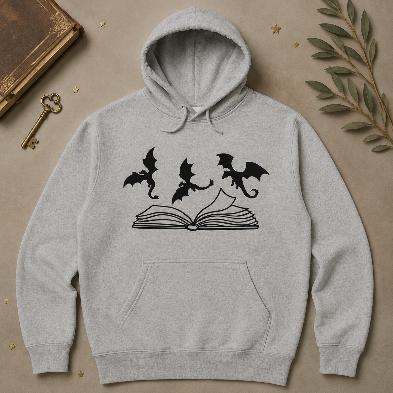 Gray hoodie with three dragons flying over an open book