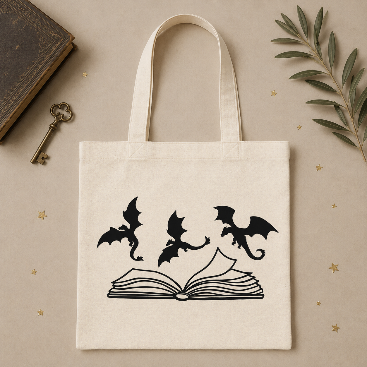 Cream tote bag with three dragons flying over an open book
